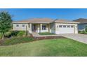 One-story home with a two-car garage and landscaping at 9400 Sw 106Th Ave, Ocala, FL 34481
