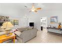 Bright living room with tile floors, a fireplace, and comfortable seating at 4980 Sw 195Th Ave, Dunnellon, FL 34431