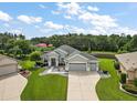 Single-Gathering home with a two-car garage and landscaped yard at 13944 Se 96Th Cir, Summerfield, FL 34491