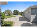 Attached garage with view of neighborhood at 12333 Se 177Th Loop, Summerfield, FL 34491