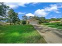 House exterior with lush lawn and driveway at 9700 Sw 194Th Cir, Dunnellon, FL 34432