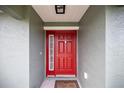 Red front door with sidelights, welcoming entryway at 4978 Sw 91St St, Ocala, FL 34476