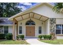 Home's entryway with double doors and stone accents at 1406 Se 48Th Ave, Ocala, FL 34471