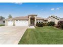 Single-story house with a three-car garage and well-maintained lawn at 5159 Nw 18Th St, Ocala, FL 34482