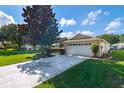 One car garage with a decorative driveway at 9541 Sw 93Rd Loop, Ocala, FL 34481