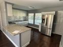 Modern kitchen with granite countertops and white cabinets at 1223 Tuskegee St, Leesburg, FL 34748