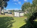 Detached shed in the backyard with a painted mural at 5120 Se 145Th St, Summerfield, FL 34491