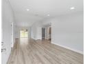 Open living area with light gray walls and wood-look flooring at 3654 Sw 149 Ter, Ocala, FL 34481