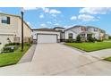 House exterior showcasing a white two-car garage and neatly landscaped yard at 5375 Sw 40Th Cir, Ocala, FL 34474