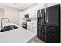 Modern kitchen with stainless steel appliances and a large island with seating at 706 Stanley Ave, Wildwood, FL 34785