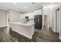 Modern kitchen featuring white shaker cabinets, quartz countertops, and stainless steel appliances at 706 Stanley Ave, Wildwood, FL 34785