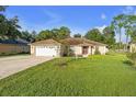 One-story house with a two-car garage and a large front yard at 16020 Se 90Th Ct, Summerfield, FL 34491