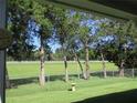 View of fenced backyard with trees and white fence at 11890 Sw 137Th Loop, Dunnellon, FL 34432