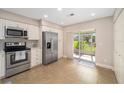 Modern kitchen featuring stainless steel appliances and white cabinetry at 2348 Se 19Th Cir, Ocala, FL 34471