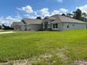 Two-story house with three car garage and green lawn at 17874 Sw 68Th Pl, Dunnellon, FL 34432