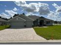 Two-story house with three car garage and brick driveway at 17874 Sw 68Th Pl, Dunnellon, FL 34432