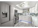 Modern white kitchen with stainless steel appliances and marble countertops at 551 Fairways Dr # A, Ocala, FL 34472