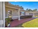 Front porch and entrance of house with red brick walkway and landscaping at 8475 Se 137Th Loop, Summerfield, FL 34491