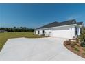 White two-car garage with a concrete driveway at 2073 Nw 79Th Loop, Ocala, FL 34475