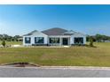 Modern farmhouse exterior with a white exterior and dark trim at 2073 Nw 79Th Loop, Ocala, FL 34475
