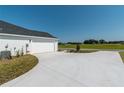 White two-car garage with a concrete driveway at 2073 Nw 79Th Loop, Ocala, FL 34475