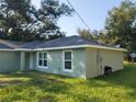 Side view of a newly built home showcasing its light green exterior at 13921 Sw 108Th Ln, Dunnellon, FL 34432