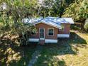 Small brown house with metal roof and front porch, situated in a wooded area at 12146 E Highway 318, Fort Mc Coy, FL 32134