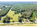 Aerial view showing home, expansive lot, and surrounding trees at 12146 E Highway 318, Fort Mc Coy, FL 32134