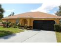 Single-story house with a two-car garage and landscaping at 2585 Sw 146Th St, Ocala, FL 34473