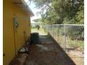 Side yard with chain link fence and AC unit at 2585 Sw 146Th St, Ocala, FL 34473