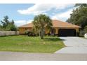 Single-story house with a two-car garage and landscaping at 2585 Sw 146Th St, Ocala, FL 34473