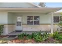 Front porch with door and brick detailing at 9755 Sw 94Th Ter # C, Ocala, FL 34481