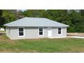 Newly constructed home with gray roof and lawn at 20114 Sw 83Rd Pl, Dunnellon, FL 34431