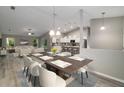 Open concept dining area with hardwood floors and stylish light fixtures at 13188 Sw 85Th Pl, Dunnellon, FL 34432