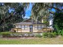 Charming house with a wooden deck and lush landscaping at 13414 Se 124Th Pl, Ocklawaha, FL 32179