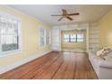 Living room with hardwood floors and built-in shelving at 13414 Se 124Th Pl, Ocklawaha, FL 32179