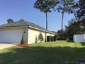 House exterior showcasing a well-maintained lawn and two-car garage at 4570 Nw 6Th Cir, Ocala, FL 34475