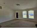 Bright living room with carpeting and two windows at 14984 Sw 28Th Terrace Rd, Ocala, FL 34473
