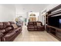 Spacious living room with two brown leather sofas at 4893 Sw 4Th Cir, Ocala, FL 34471