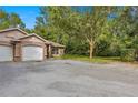 Tan duplex with 2-car garage, and a well-manicured lawn at 2635 Ne 7Th St # 104, Ocala, FL 34470