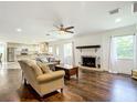 Spacious living room with hardwood floors, a fireplace, and built-in shelving at 4010 Sw 7Th Avenue Rd, Ocala, FL 34471