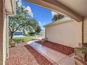 Covered front porch with wicker seating and a view of the yard at 1949 Lancaster Ln, The Villages, FL 32162