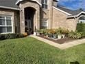 Welcoming front entry with brick facade and potted plants at 3403 Gatlin Place Cir, Orlando, FL 32812