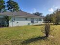 House exterior showcasing the backyard and surrounding landscape at 19 Cedar Dr, Ocala, FL 34472
