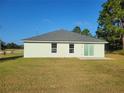 House exterior showcasing a sliding glass door and backyard at 19 Cedar Dr, Ocala, FL 34472