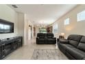 Living room with black reclining sofas and view of kitchen at 6094 Sw 93Rd Cir, Ocala, FL 34481