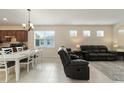Dining area with white table and chairs adjacent to living room at 6094 Sw 93Rd Cir, Ocala, FL 34481