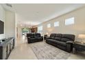 Living room with black reclining sofas and view of kitchen at 6094 Sw 93Rd Cir, Ocala, FL 34481