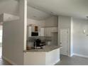 Modern kitchen with white cabinets and breakfast bar at 6925 Sw 179Th Court Rd, Dunnellon, FL 34432