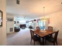 Spacious dining area with chandelier and access to the living room at 7366 Sw 115Th Pl, Ocala, FL 34476